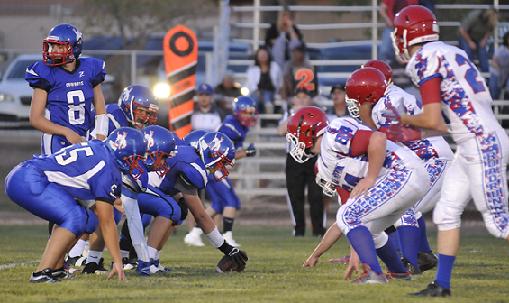 Friday night, Aug. 29, Camp Verde High School lined up head-to-head on the gridiron with Holbrook High School in the Cowboys' opening home game of the season. Sophomore quarterback Payton Sarkesian, No. 8, makes sure his offense is set before the snap.