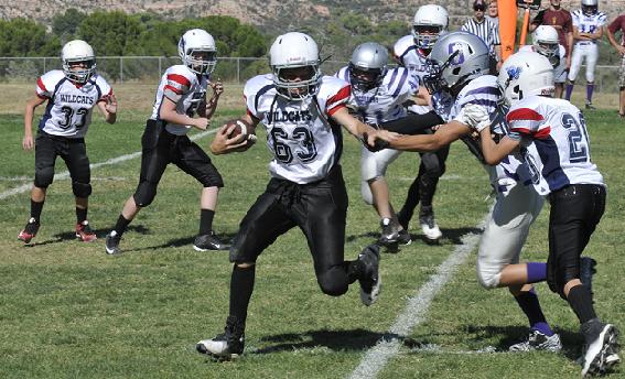 Cameron Reid, No. 63, a running back for the Cottonwood Wildcats, strong-arms his way to the edge during his team’s lone win Sept. 26, 33-6 over the Sedona Scorpions. Head Coach Jackie Bessler’s Wildcats will attempt to pull the upset at top Majors team Wickenburg on Saturday, Oct. 23, in the first round of the Northern Arizona Youth Football playoffs.