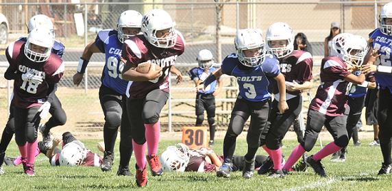 Corey Johnson makes a solid run, before being downed by a Cottonwood Colts group tackle. The game, at Camp Verde High School’s field, resulted in a loss for the Coyotes, 41-12. The Camp Verde Youth Football minors team will take on Bagdad on Saturday, Oct. 17.