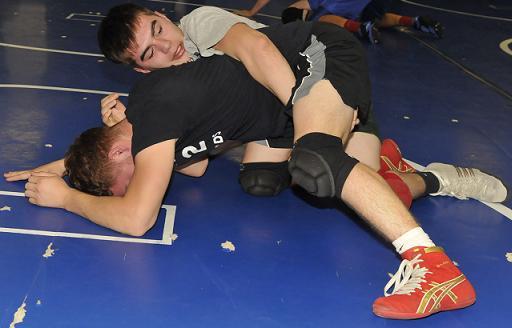 Senior Alex Casillas, top, a 113-pound wrestler at Camp Verde High School, attempts to pin his brother, Ezekiel, a junior, during practice at the Sterrett Wrestling Complex. Casillas is one of three state champions leading the Cowboys into their opening meet Tuesday, Nov. 24, at home against six other schools.