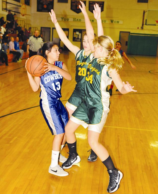 Eighth-grader Amanda Lozania, left, looks to pass to another Cowboy out of pressure applied from a Clarkdale-Jerome School double team. The Mingus Rams went to 2-2 after a victory Thursday, Nov. 19, over Pine Strawberry Elementary School.