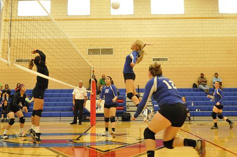 Junior Shelby Ritzenthaler jumps high to slam the ball across the net for Camp Verde High School at home against Many Farms High School. The Cowboys lost their Oct. 10 section opener, three games to one, and all other section matches afterward.