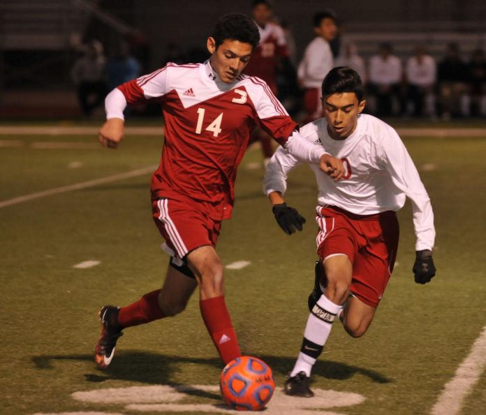 Senior midfielder Martin Hernandez, right, vies for control of the ball for Mingus Union High School with Bradshaw Mountain High School senior forward Noe Morales. The Marauders lost, 3-0, to the Bears in their home opener Tuesday, Dec. 1.