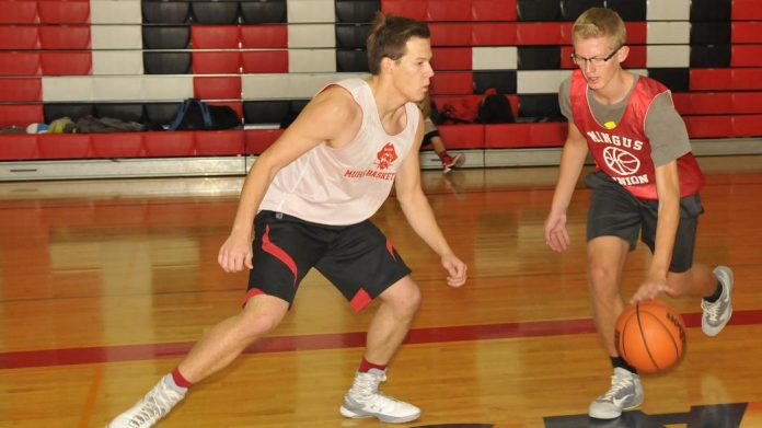 Mingus Union High School boys basketball seniors Kyle Houston, left, and Joe Doerksen practice guarding drills during practice. Houston and Doerksen are the tallest players for the 0-1, guard-heavy Marauders this season.