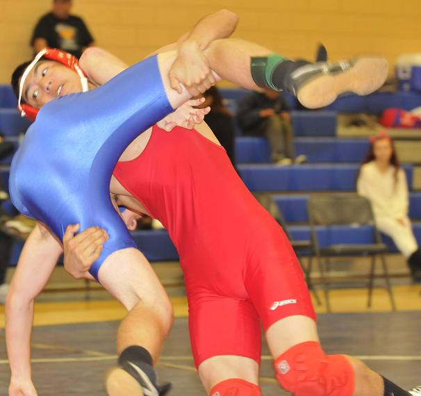 Tyre Kim, right, a sophomore at Mingus Union High School, attempts to pin Mayer High School junior Wyatt Frye at a wrestling meet Jan. 12 at Camp Verde High School. Kim went on to defeat Frye and finish 2-1 at the four-team multiple meet.