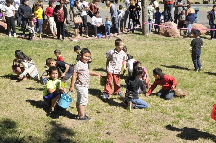 Kids rush the field at the word go, vigorously scrambling for candy.