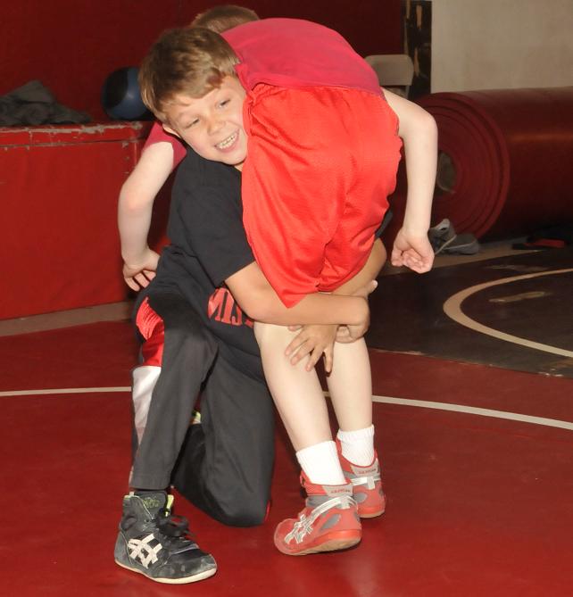 Nathan Dixon, front, attempts to pin fellow 9-year-old Mingus Mountain club wrestler Elias McKean. Dixon, who is also a white belt in jiujitsu, followed a state wrestling title in his weight division Feb. 20 with a gold medal a week later at the Phoenix Grappling Championships for local jiujitsu coach Ted Osburn.