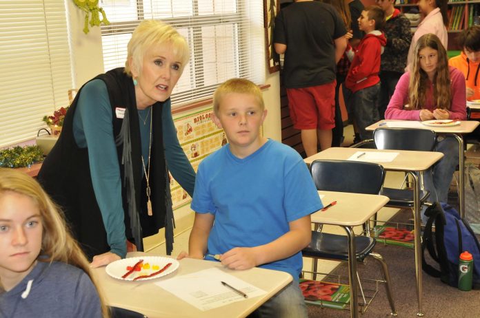 Debbie Emery, a leadership process leader from the Flippen Group chats with Ty Holman, an eighth-grader at Camp Verde Middle School, about the science project he was working on. Emery toured the school in December, one of 11 finalists out of around 400 schools that are candidates for the program’s Showcase School. Now, CVMS has been named Capturing Kids’ Hearts National Showcase School.