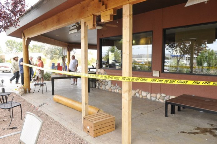 Employees of Jerona Cafe tape of the patio after an SUV knocked over one of its pillars.