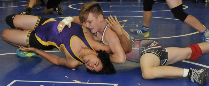 Junior Hayden Uhler, top, gets a Weekend Wars opponent in a hold prior to pinning him on the Sterrett Wrestling Complex mat. Uhler is undefeated through the first three off-season wrestling tournaments at Sterrett, while younger brothers Korben, Racer and Rhett Uhler have all captured first place in their weight classes in the meets. The next Weekend Wars will be Saturday, June 11.