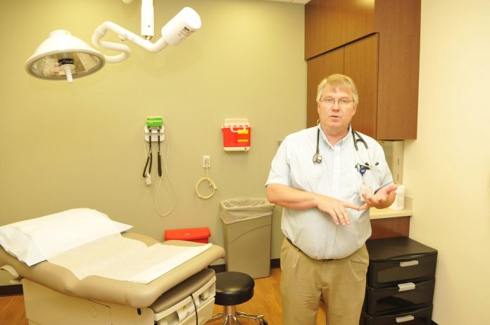 Zack Garcia/Larson Newspapers Dr. John Rooney, head physician at Northern Arizona Healthcare’s new Camp Verde Campus, stands in one of the new exam rooms. The campus will be structured as a same-day clinic, focused on efficiency and flow, eventually leading to patients self-rooming.