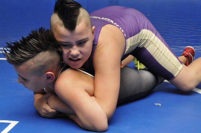Joey Zepeda, top, wrestles his younger brother Ethan at Camp Verde’s Sterrett Wrestling Complex. They also traveled with their father, a Muay Thai and boxing coach, to tournaments in Florida, Iowa and New Mexico.