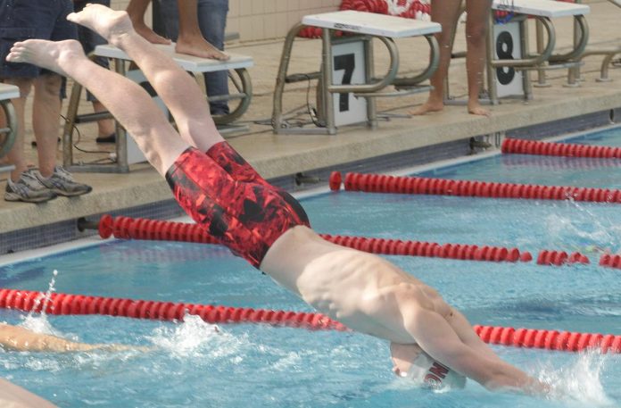 As his teammate touches the wall, Mingus Union High School sophomore Fletch Fangman dives in as the second swimmer in a relay race. The Marauders swim team opened its season with a win over Northland Preparatory Academy.