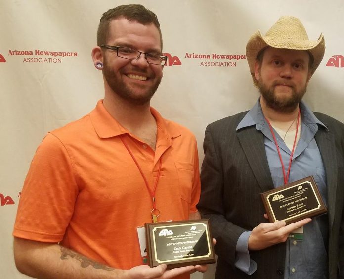 Photojournalist Zack Garcia, Managing Editor Christopher Fox Graham, from left, display some of the awards won by Larson Newspapers at the Arizona Newspapers Association Fall Convention.