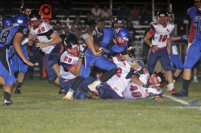 Camp Verde High School junior quarterback Payton Sarkesian runs the ball up the gut in a game earlier this season. The Cowboys lost 54-6 to Paradise Honors High School Saturday, Oct. 1, in Surprise.