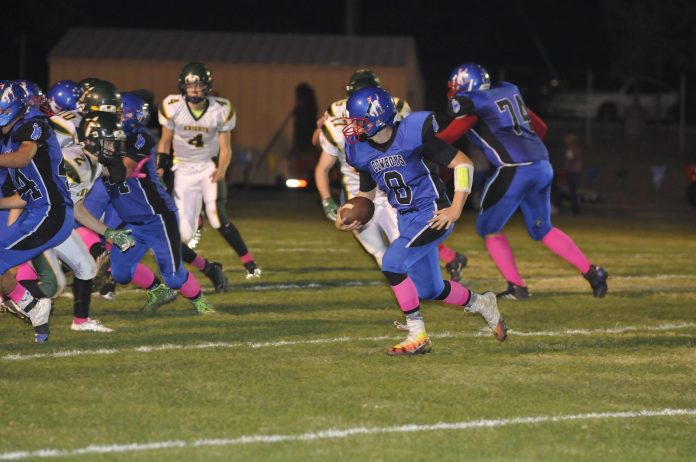 Junior quarterback Payton Sarkesian rolls out during Camp Verde High School’s 24-20 home loss to Gilbert Christian Friday, Oct. 21. Sarkesian ran for a touchdown and passed for two others to senior Carson Zale for the Cowboys.