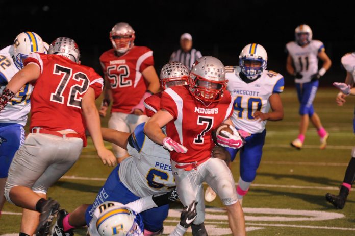 Tyler Kelly carries the ball during Mingus Union High School’s 48-12 win over visiting Prescott High School Friday, Oct. 7. The junior ran for 36 yards on three carries, and had an interception and a quarterback sack.