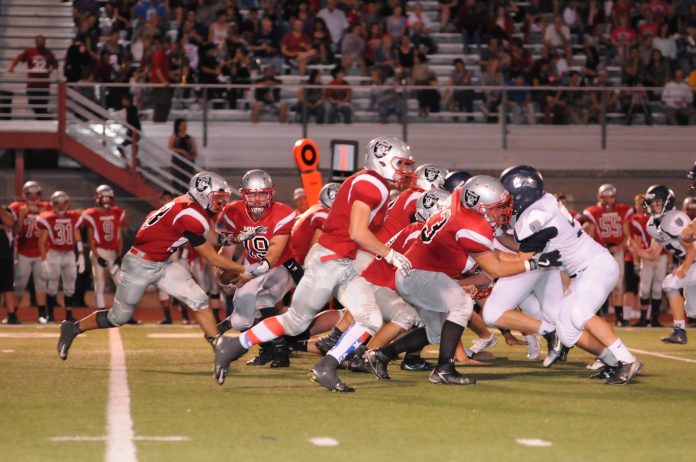 Senior quarterback Trey Meyer reads the defense as he fakes a handoff to senior Juan Ruiz in a Mingus Union High School game earlier this season. The Marauders on Friday, Oct. 21, dominated visiting Coconino High School, 78-6, as Meyer completed six of eight passes for three touchdowns, including one to Ruiz, and ran for two other scores.