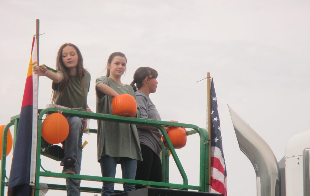 Three girls toss candy from a Tierra Verde Retals truck at the 70th Annual Fort Verde Parade on Saturday, Oct. 10, 2026.